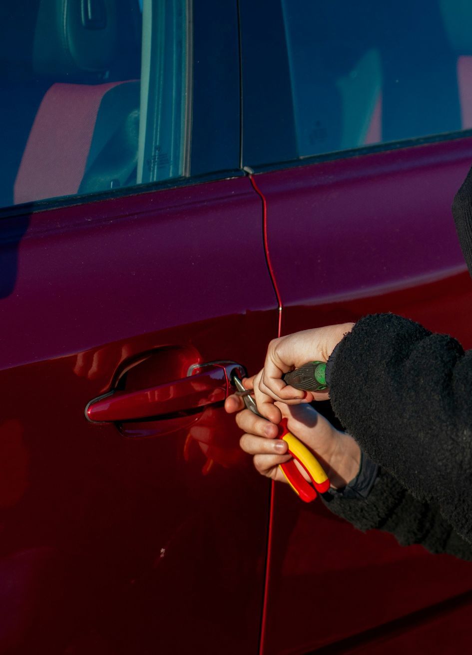 A person is trying to break into a car